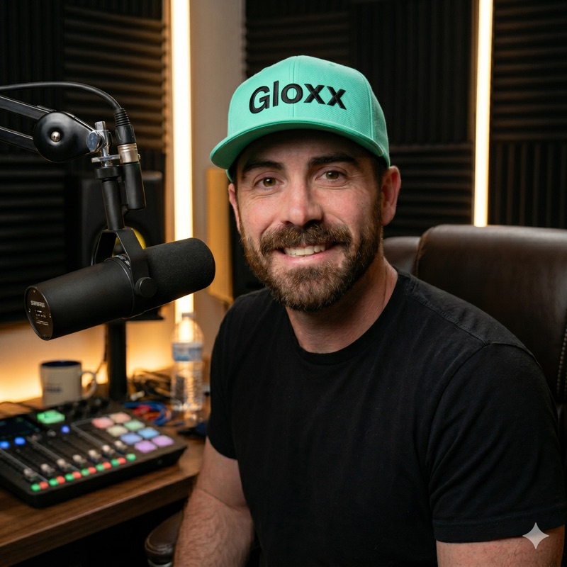 Bran, Founder of Gloxx, at a podcast microphone wearing a green Gloxx cap